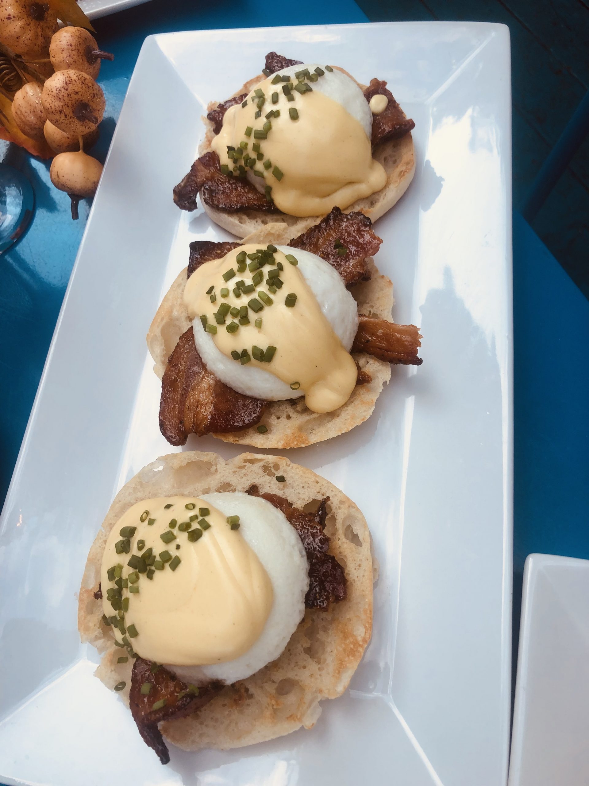 Eggs with Bacon on English Muffins on a table.