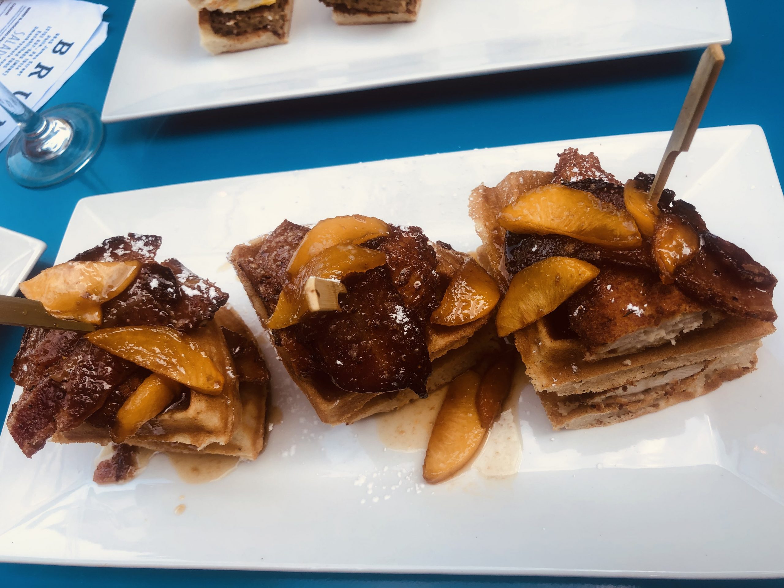 Waffles with bacon and pecans on a plate.