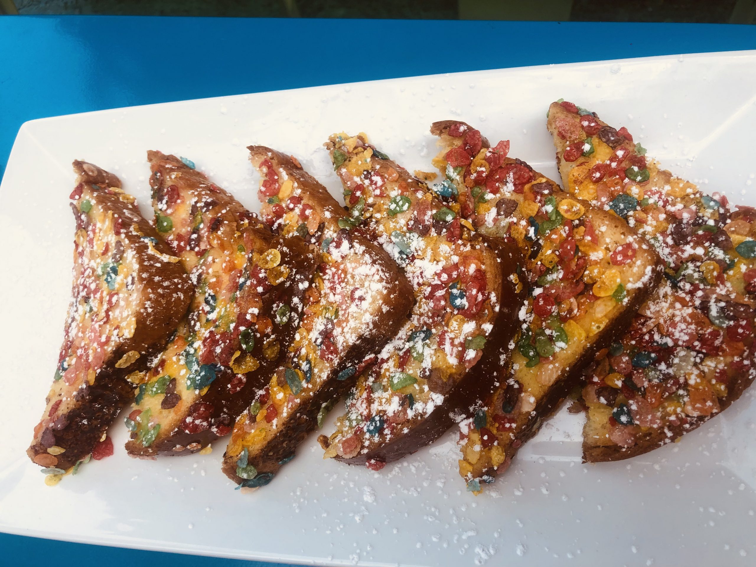 A plate of french toast with sprinkles on it.