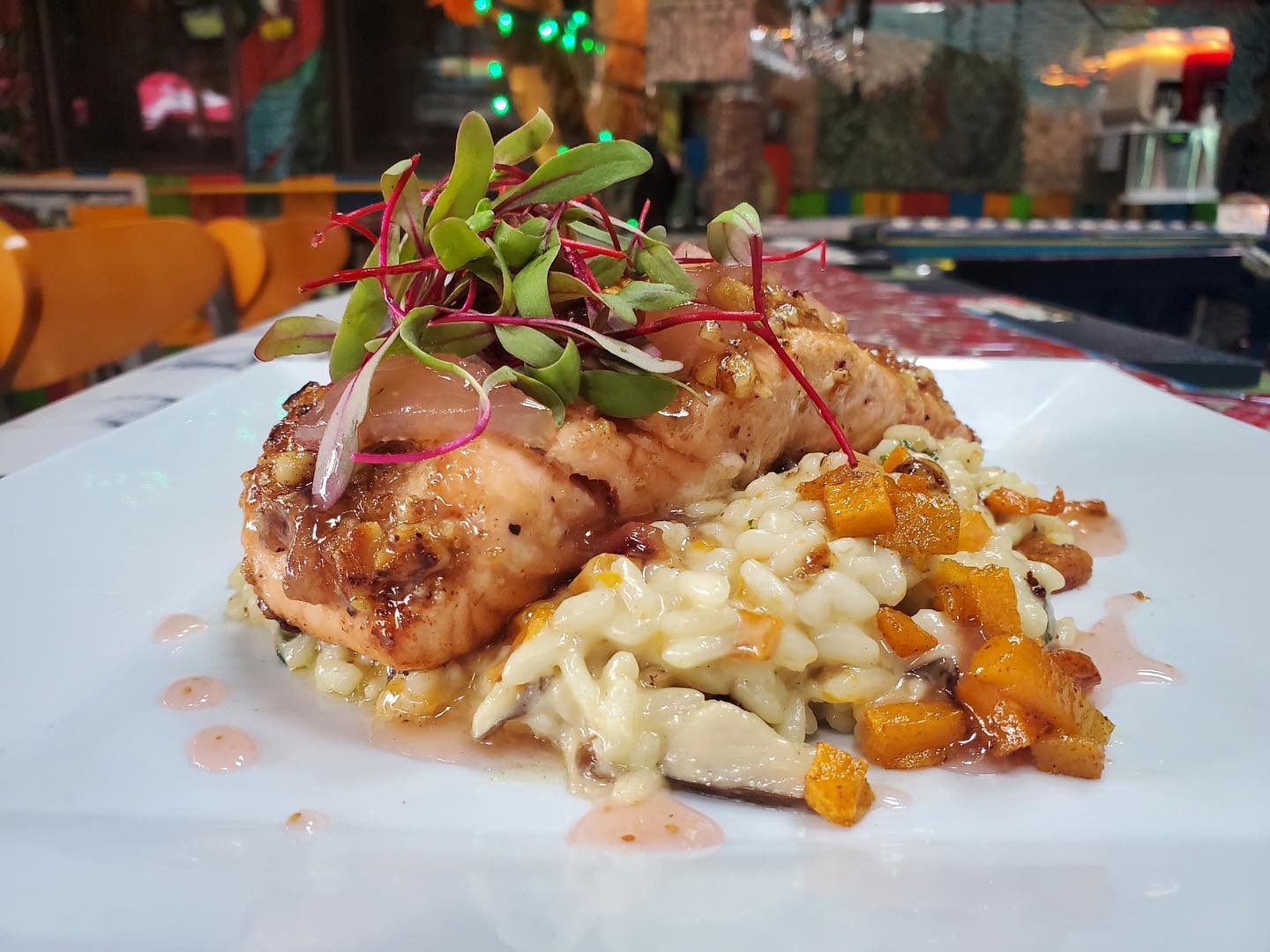 A plate with salmon and risotto on it.