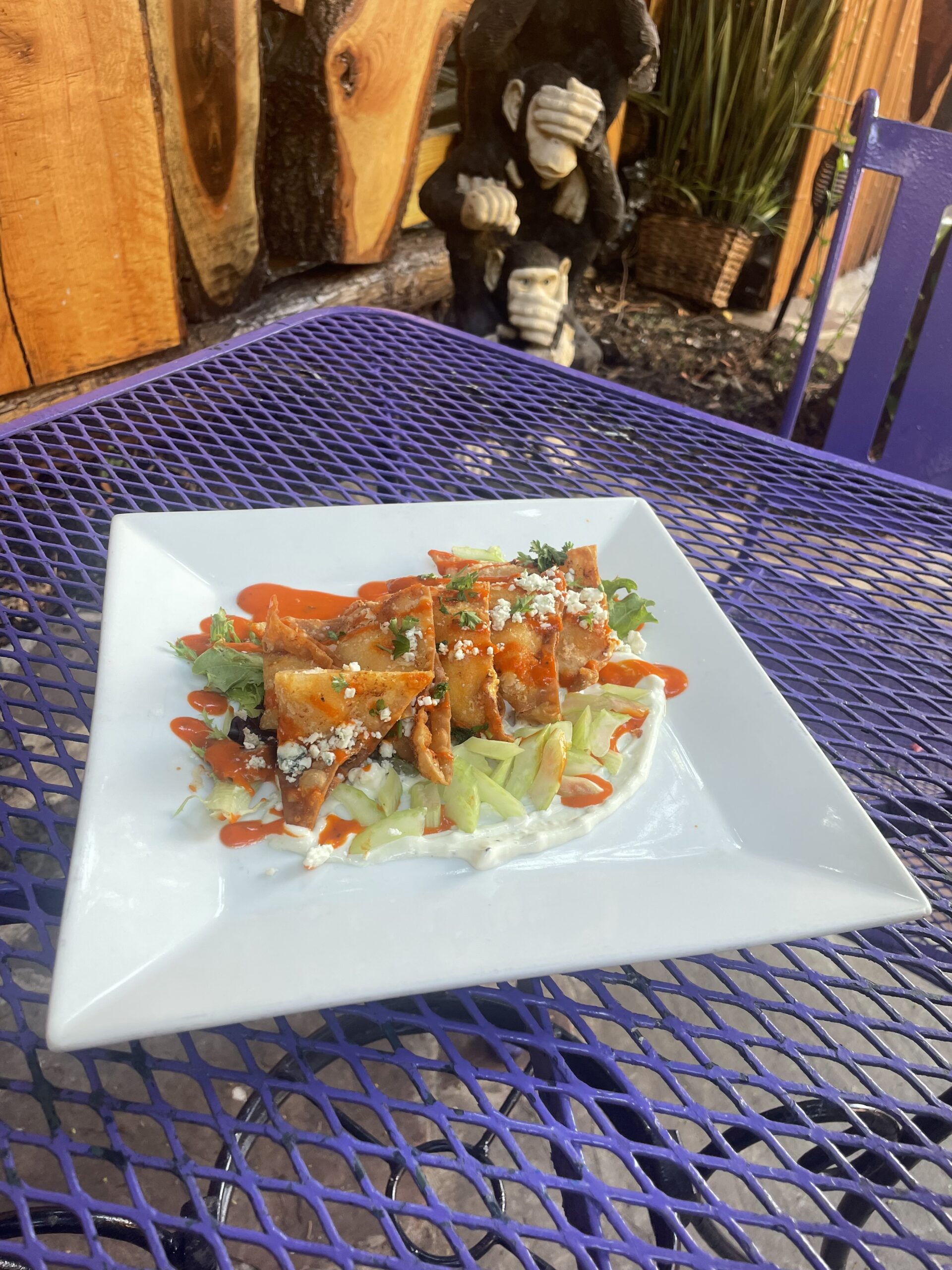 A plate of food is sitting on a purple table.